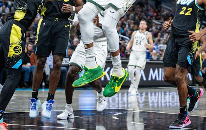 Milwaukee Bucks forward Giannis Antetokounmpo's green and yellow Nike sneakers.